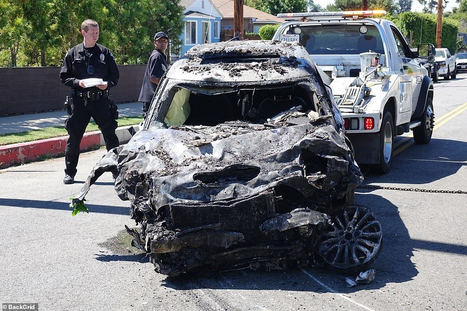 The 53-year-old suffered horrific burns during the collision and was recorded being dragged out of the mangled wreck by firefighters after it burst into flames in Los Angeles around 11 a.m. on August 5. Pictured: Heche's wrecked mini is towed away from the crash site